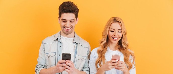 two people holding smartphones