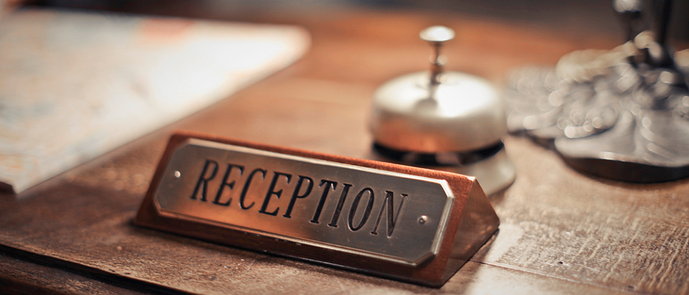 An old-fashioned hotel reception desk sign